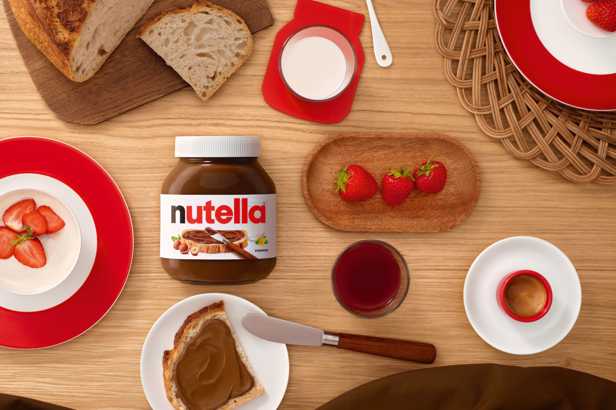 Colazione con Nutella: pane, fragole, latte e caffè. Icona globale.
