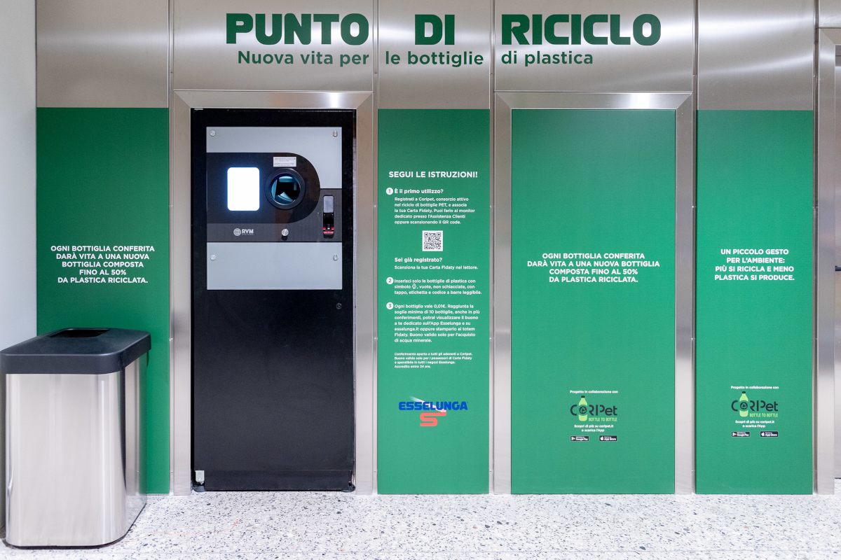 Punto di riciclo automatico per bottiglie in PET Coripet presso un supermercato Esselunga con istruzioni e QR code.