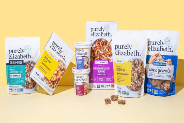 Selezione di prodotti Purely Elizabeth, brand acquisito da Ferrero, tra cui granola, cereali e avena su sfondo giallo.