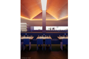 La Vetta Italian restaurant interior in Savannah. Contemporary dining room with blue seating, tables, and open kitchen view.