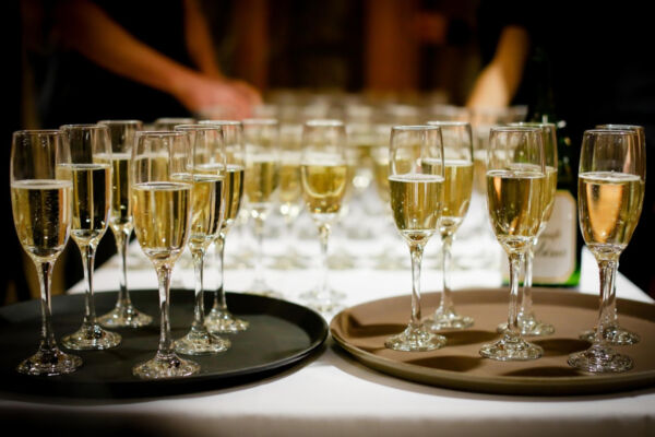 Air India, PriSecco, Italian sparkling wine glasses on trays. Celebration with Prosecco or Spumante. Wine tasting event.