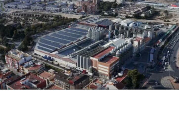 Estrella de Levante brewery aerial view. Damm Group facility with solar panels, tanks, and industrial buildings.