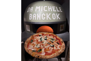 Da Michele Bangkok pizzeria. Neapolitan pizza with basil and mozzarella in front of a pizza oven.