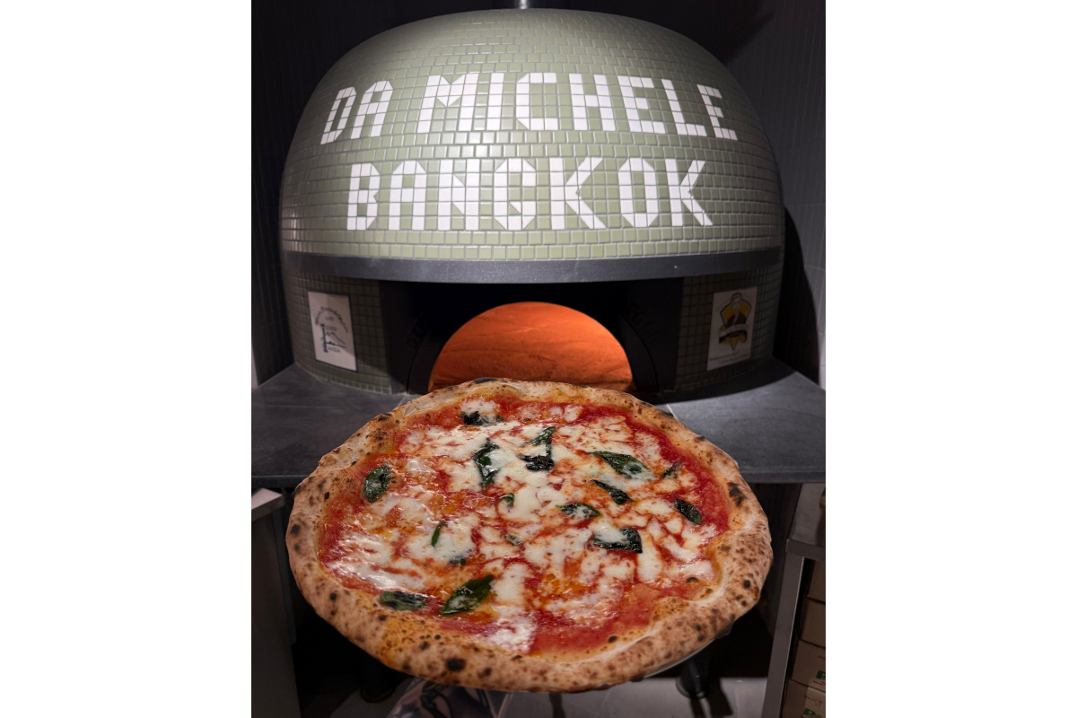 Da Michele Bangkok pizzeria. Neapolitan pizza with basil and mozzarella in front of a pizza oven.