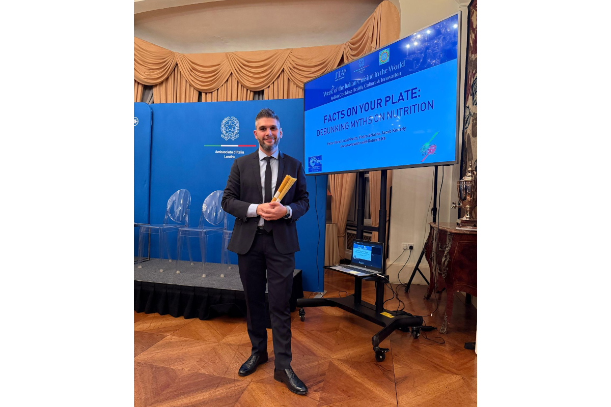 Italian Cuisine Week 2025: Nutrition presentation with speaker in suit.