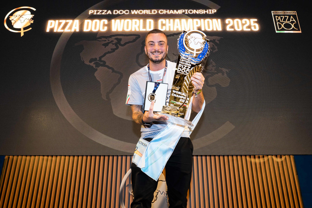 Pizza DOC World Champion 2025: Giuseppe Cutraro wins the Pizza DOC Championship, holding the trophy and medal.