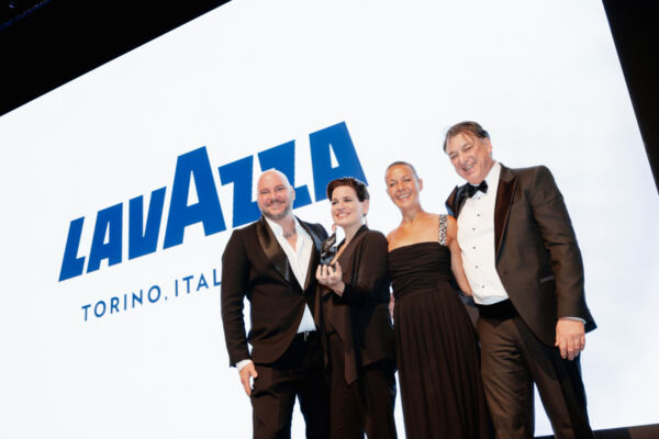 Lavazza wins Best European Commercial Coffee Roaster award. Group of people on stage with Lavazza logo.