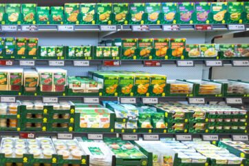 Lidl Vemondo vegan product selection on grocery store shelves in Italy. Plant-based burgers, dips, and snacks.