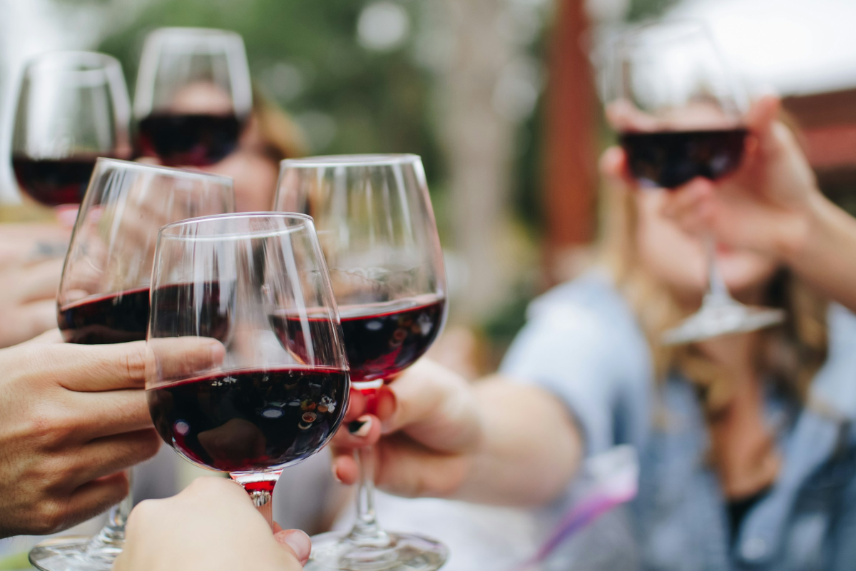 Italian wine-People toasting with red wine glasses. Celebration, cheers, and friendship.