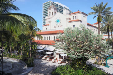 Eataly West Palm Beach, Florida. Italian marketplace with restaurants, shops, and palm trees. Outdoor dining.
