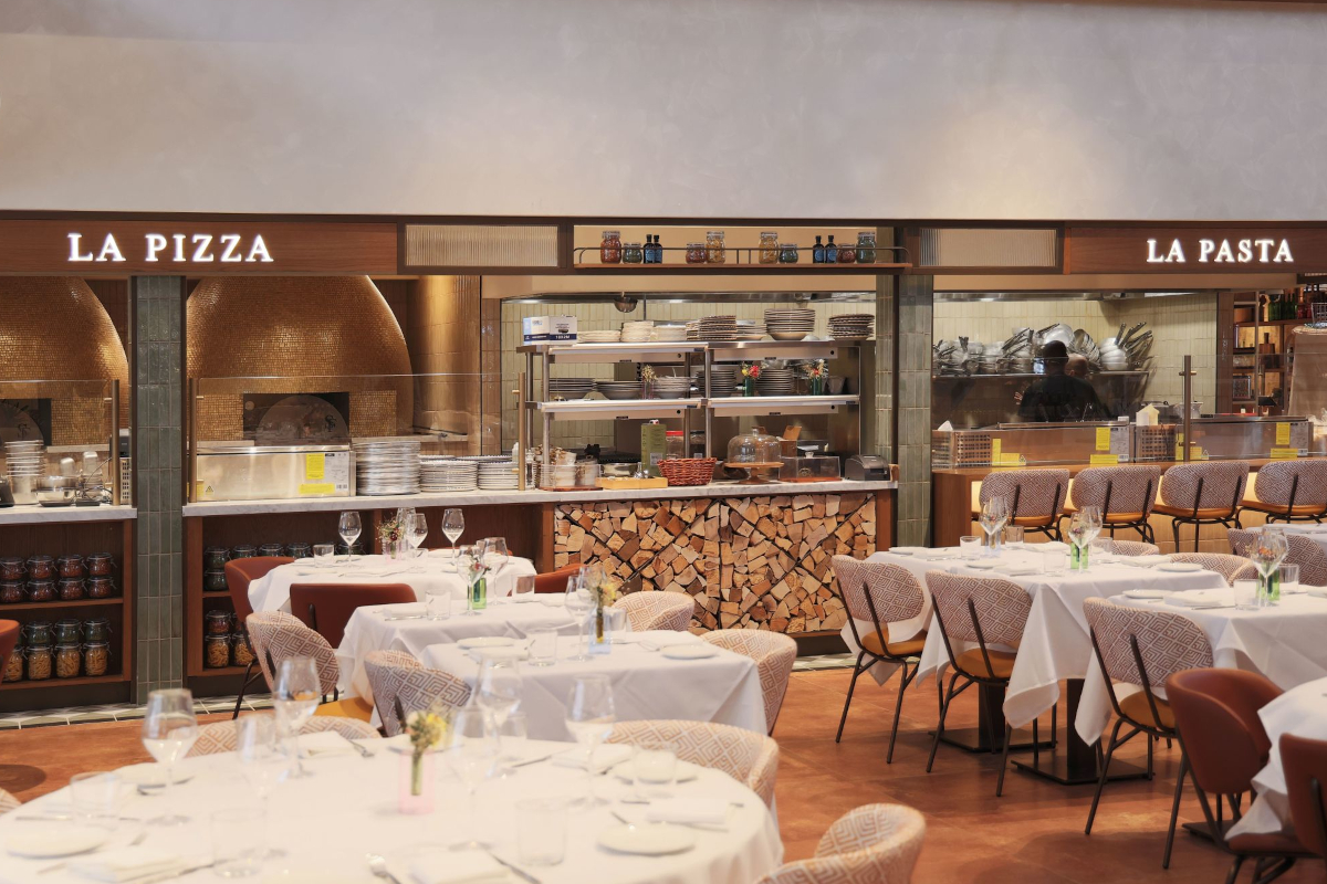 Eataly West Palm Beach restaurant. La Pizza and La Pasta food stations, tables, and chairs.
