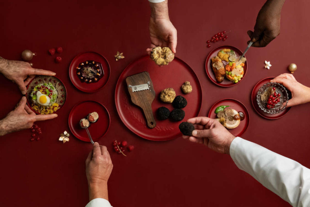 Urbani Tartufi campaign featuring black and white truffles, truffle slicer, and truffle-infused dishes on red plates.