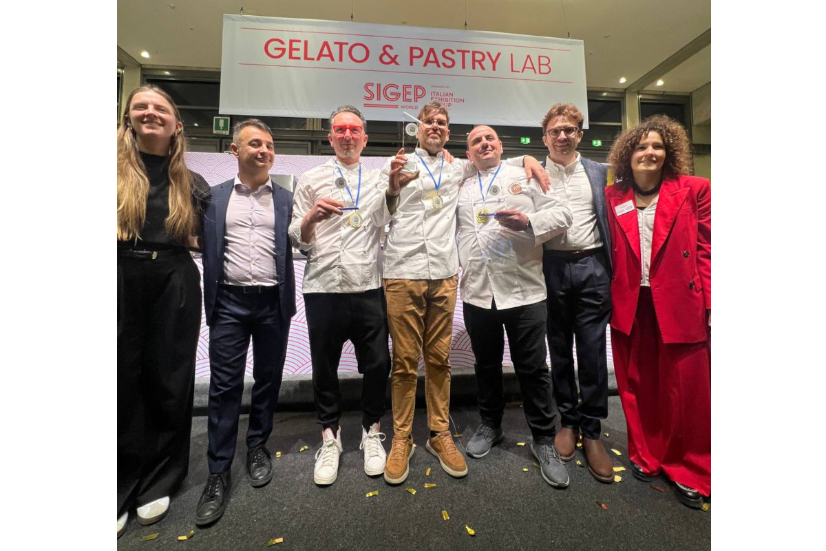 Panettone finalists on stage at SIGEP Italian food event. Chefs with medals celebrate traditional Italian pastry.