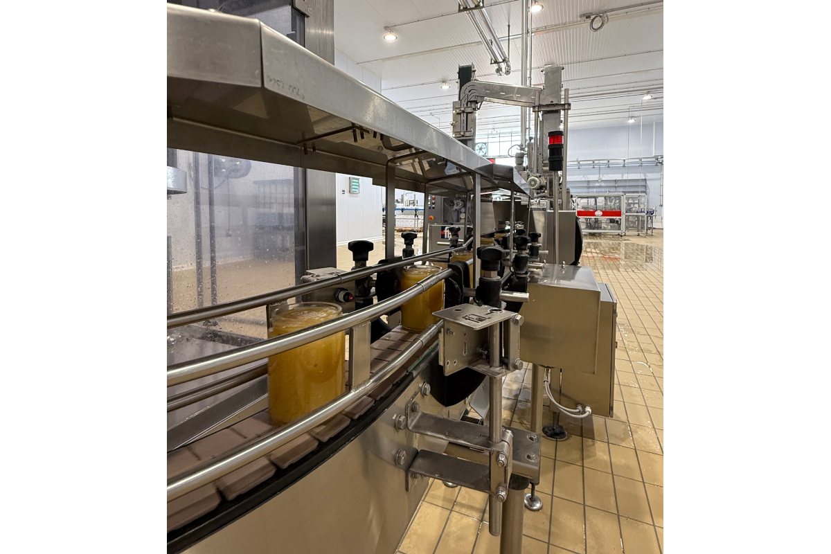 Agrisicilia factory: Jars on a conveyor belt. Food production line in a food processing plant.