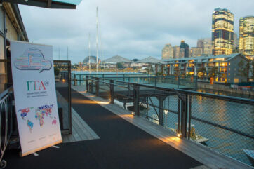 ITA Sydney event celebrating Italian cuisine. Harbour view with Italian Trade Agency banner.