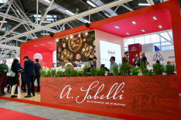 Sabelli Group food expo booth. Italian food brand display with pizza and cheese. Trade show exhibit.