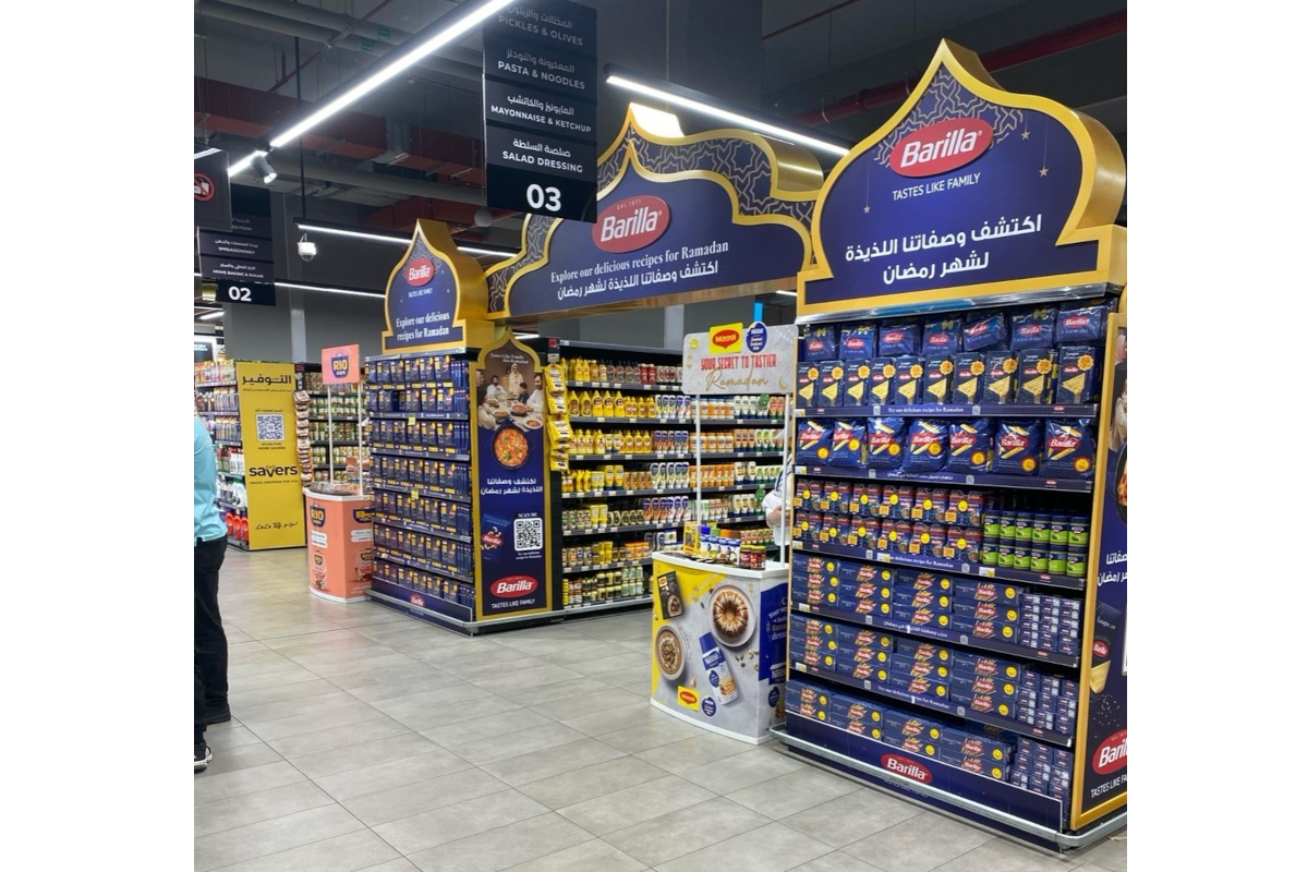 Grocery store aisle with Barilla pasta displays for Ramadan. Shelves stocked with pasta and sauces.