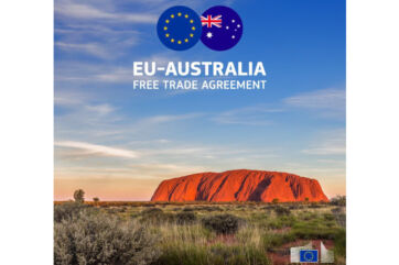 EU-Australia trade agreement. Flags of Australia and EU over Ayers Rock.