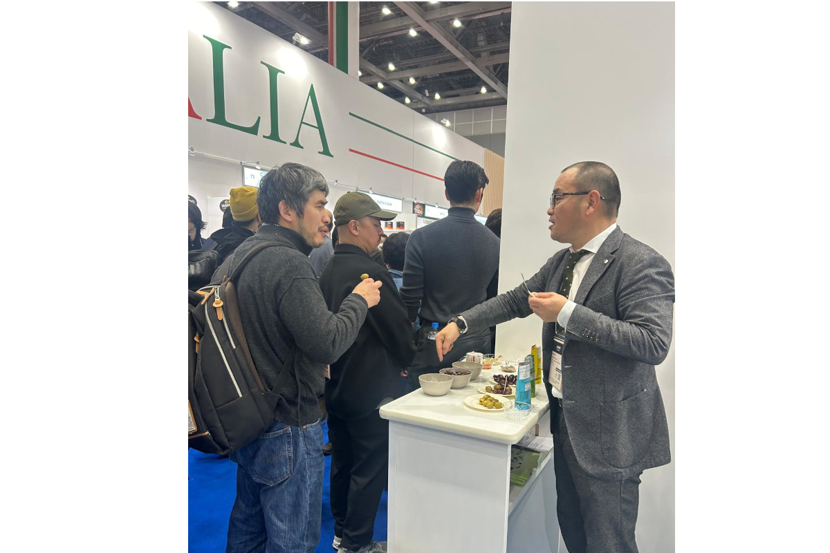 Foodex Japan: People sampling Italian olives at Madama Oliva food expo.