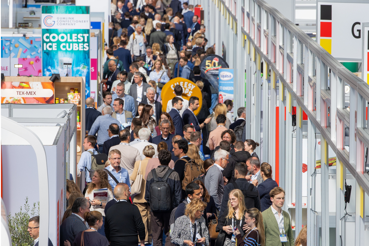Crowd of people at a PLMA trade show. Attendees at a private label event. Business and retail industry fair.