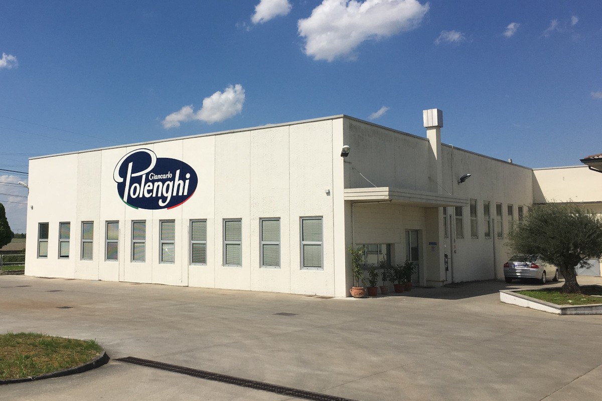 Polenghi headquarters building exterior. Polenghi Giancarlo logo on white facade. Food industry company.