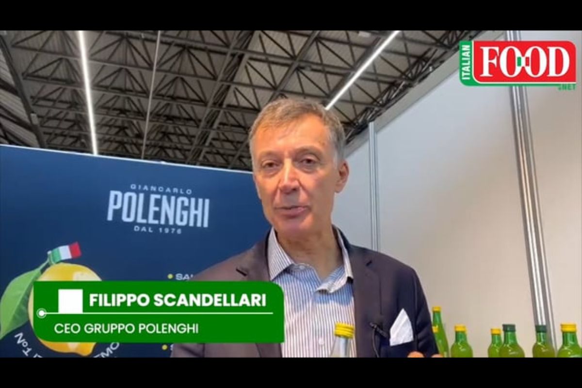 Filippo Scandellari, CEO Gruppo Polenghi, stands before Polenghi Sicilian lemon juice display. Polenghi celebrates 50 years.