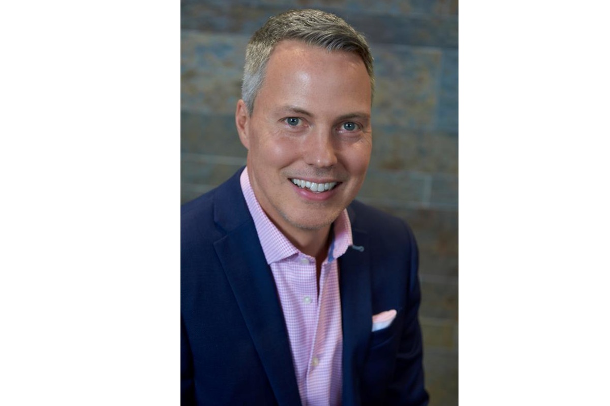 Professional headshot of Bill Lynch wearing a navy blue blazer, pink checkered dress shirt, and a white pocket - Summer Fancy Food Show 2026square.