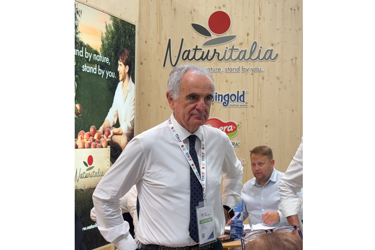 Gabriele Ferri at the Naturitalia trade show booth, promoting fresh Italian fruit and produce to industry professionals.