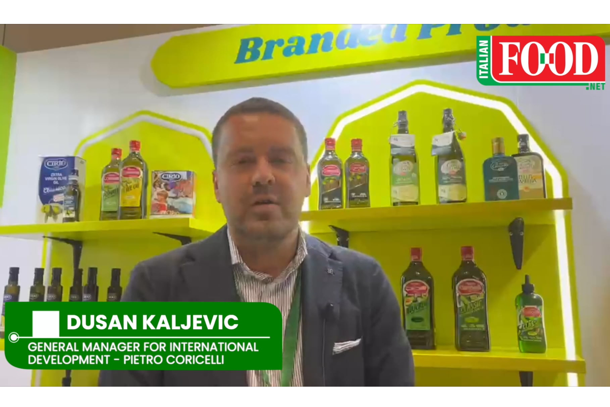 Dusan Kaljevic, Pietro Coricelli General Manager, at a trade show booth displaying Cirio and Pietro Coricelli olive oil.