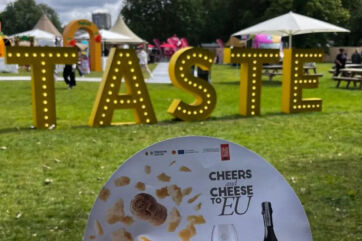Cheers to Cheese sign at Taste of London 2026 featuring Grana Padano PDO and Prosecco PDO branding in a park setting.