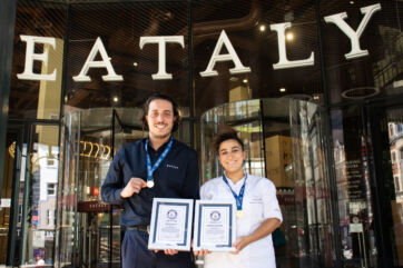 Eataly London staff holding Guinness World Record certificates for the 440.58-metre long tiramisu outside the store.