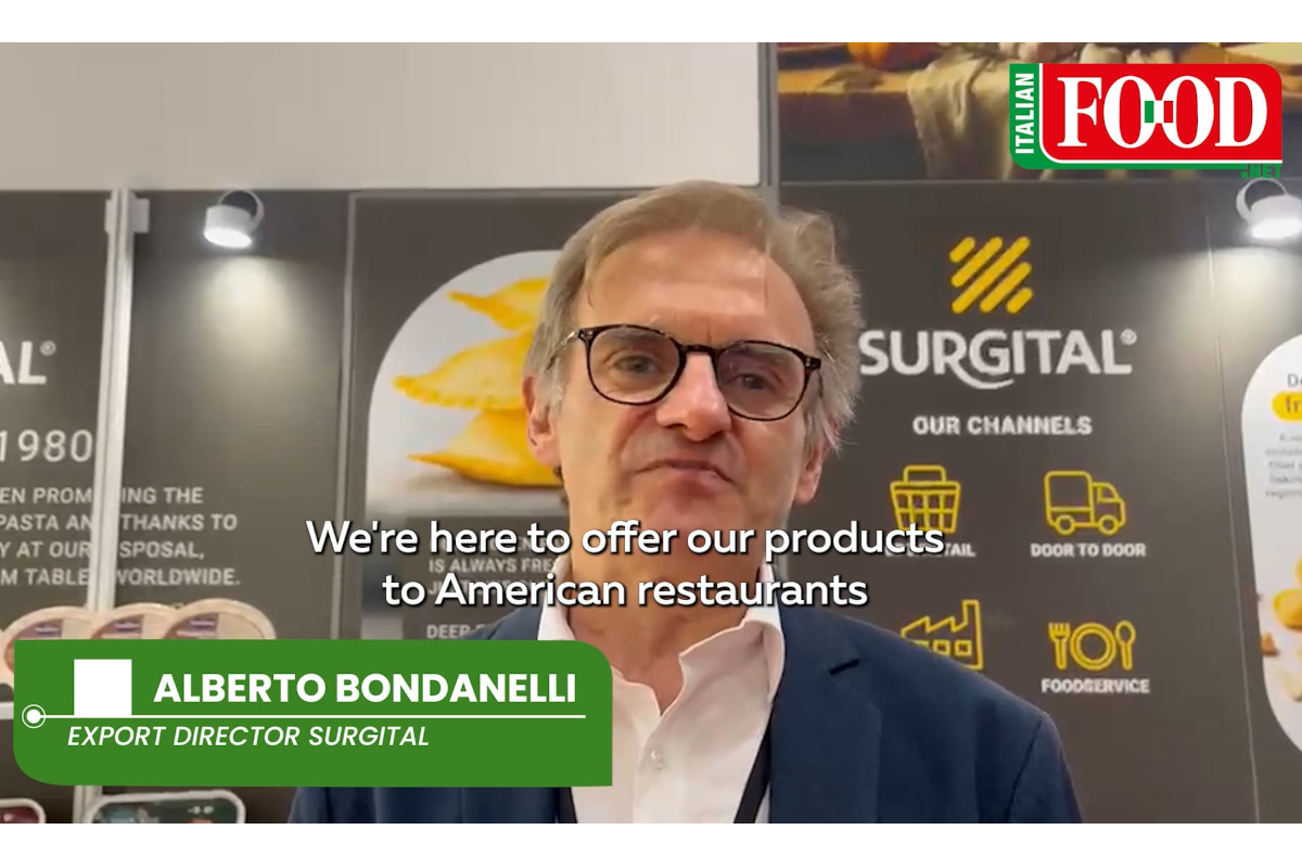 Alberto Bondanelli of Surgital discusses artisanal Italian pasta for US foodservice at a trade show booth.