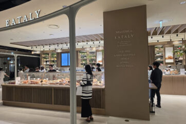 Modern Eataly store interior in Seoul Gangnam with a glass pastry display, Italian food signage, and customers shopping.