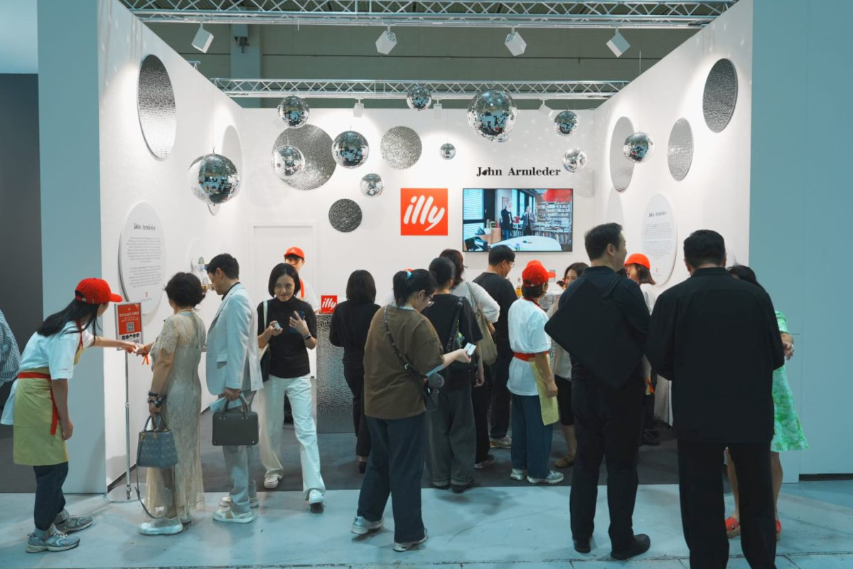 Visitors at the illy Art Collection booth by John Armleder at Frieze Seoul, featuring disco balls and illy branding.
