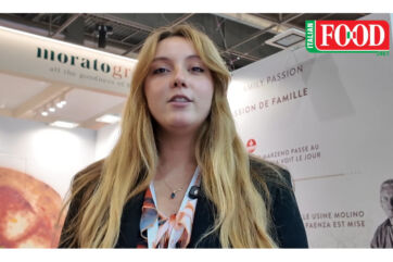 Molino Naldoni representative at SIAL Paris 2026, Italian Food banner, Morato booth and family passion backdrop.