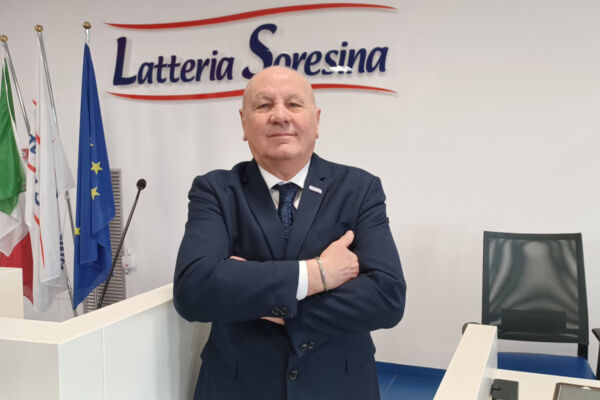 Tiziano Fusar Poli, President of Latteria Soresina, standing before the company logo after Saviola merger.