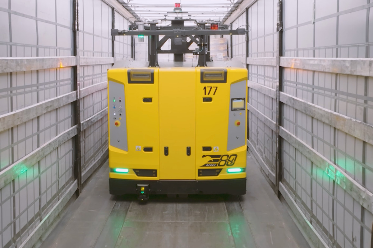 E80 Group yellow automated LGV inside a truck trailer for last-mile intralogistics and automated truck loading.