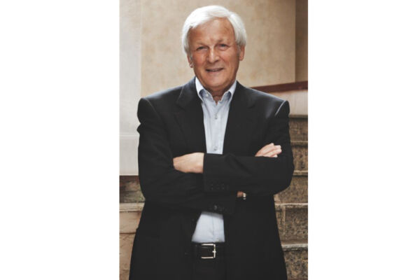 Loriano Bagnoli, ritratto formale. Uomo in giacca e cravatta, capelli bianchi, posa professionale.