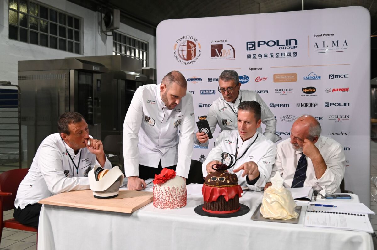 Giuria del Panettone World Championship 2025 a HostMilano valuta panettoni decorati.