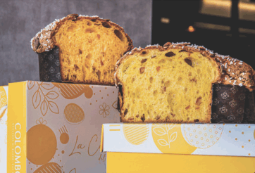 Sezioni di Colomba Piuma di Claudio Colombo su scatole. Dolce pasquale artigianale con glassa e canditi.