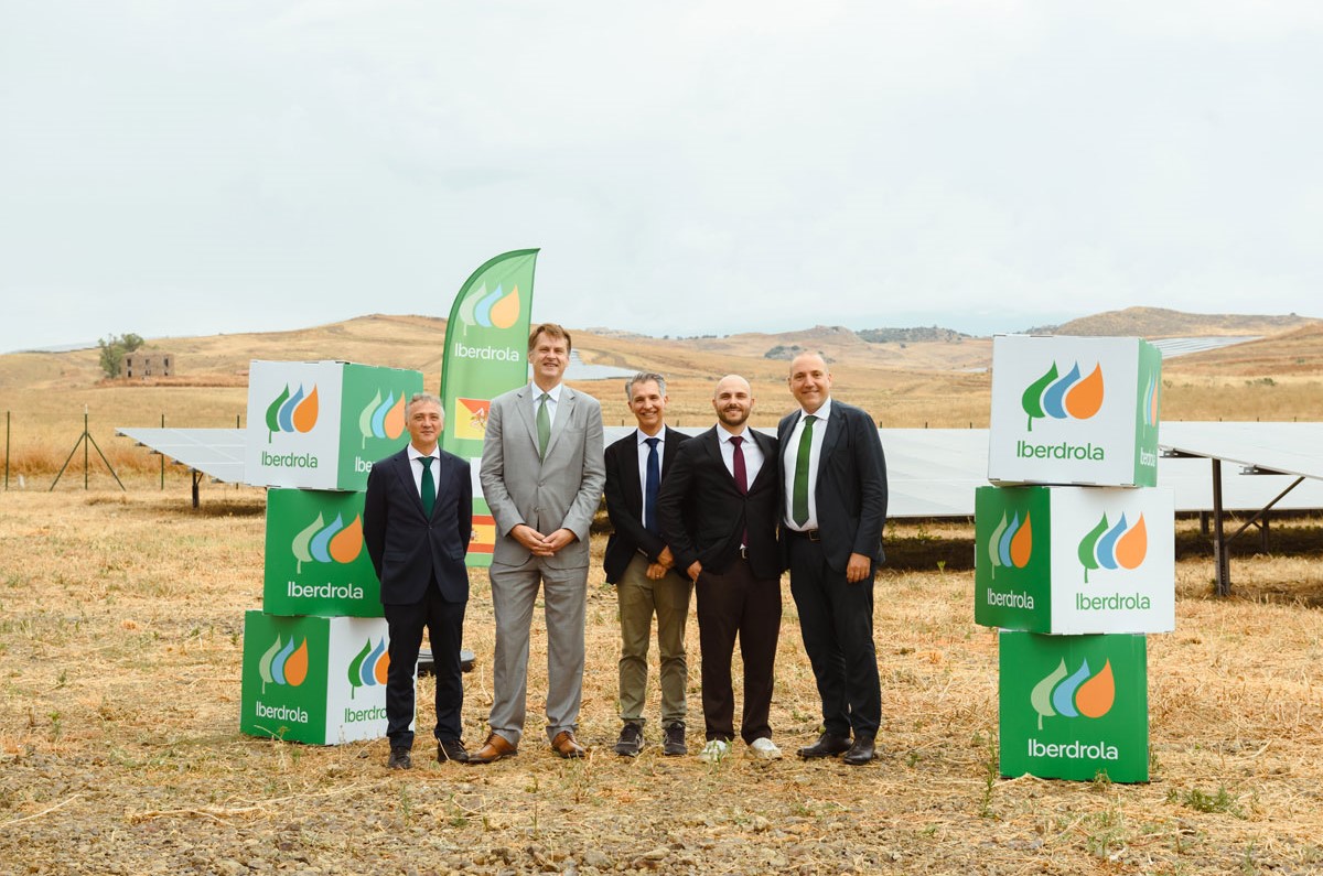 Manager di Pam Panorama e Iberdrola Italia in posa davanti a un impianto fotovoltaico per la transizione energetica.