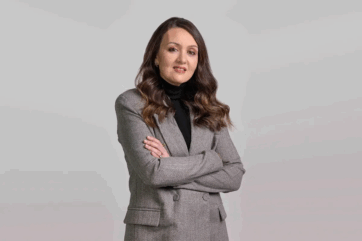 Elisabetta Debole di L'Oréal, ritratto professionale in giacca grigia.