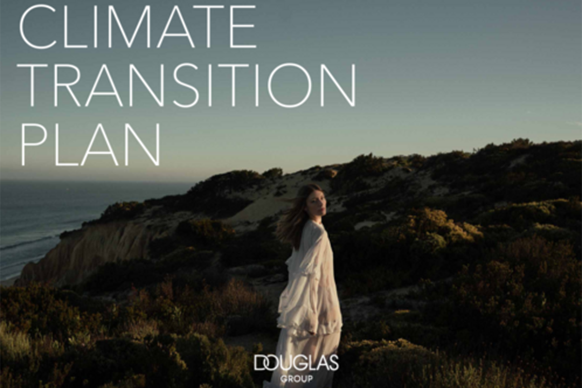 Donna in abito bianco su scogliera al tramonto con testo Climate Transition Plan e logo Douglas Group.